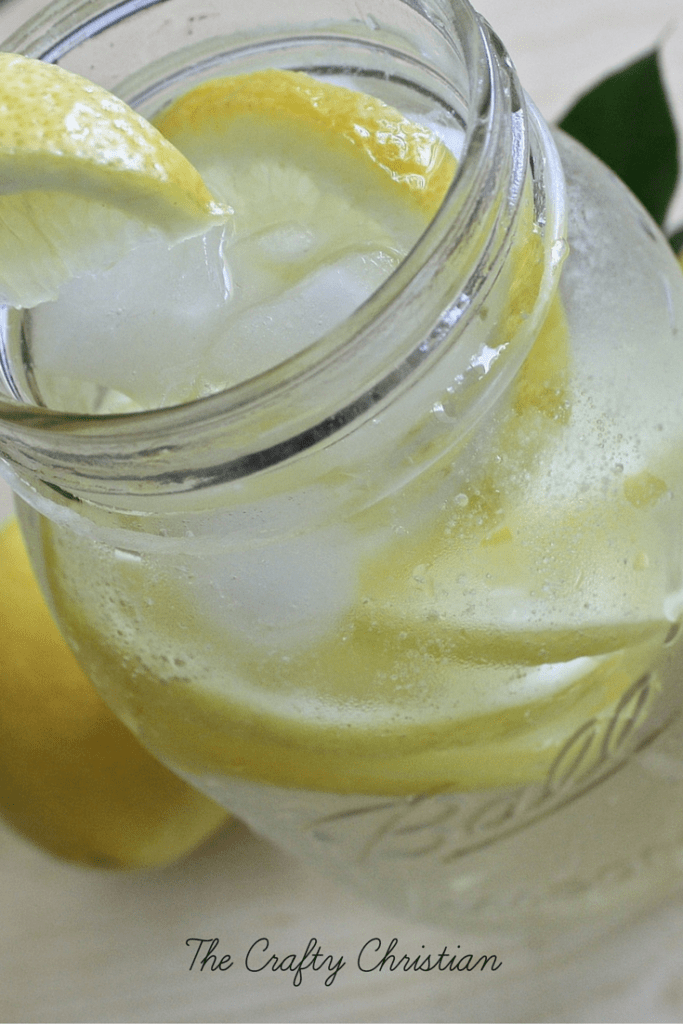 Lemons and ice in a mason jar filled with water