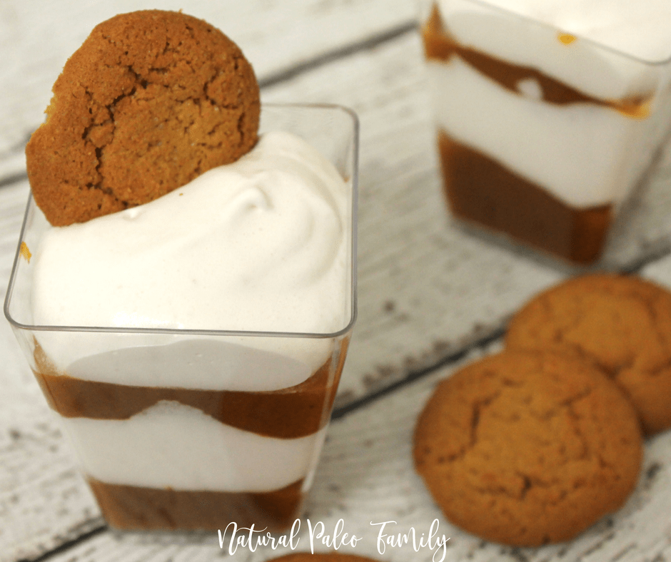 Pumpkin pie parfait in a clear cup with a ginger snap in the top