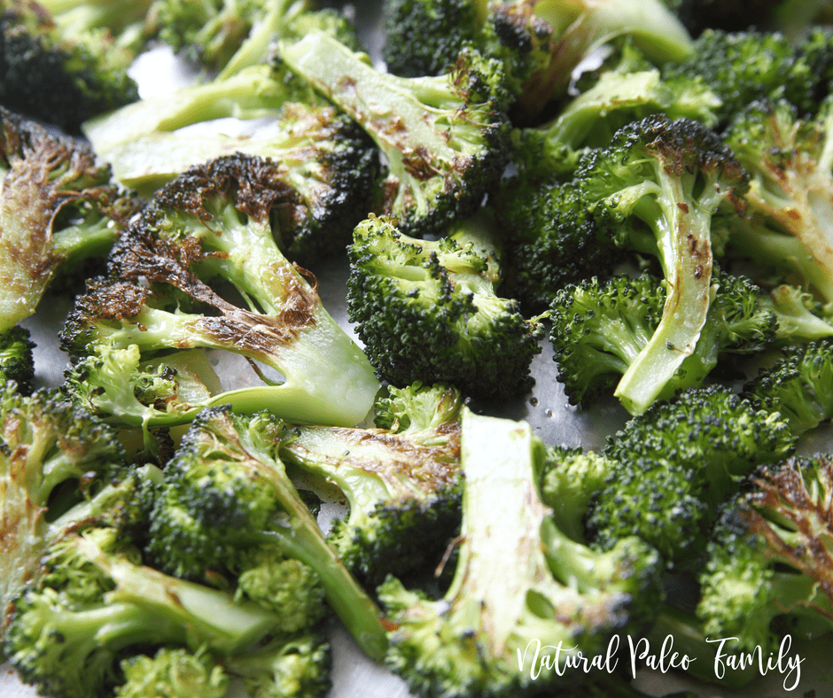 Closeup of garlic roasted broccoli on a baking sheet