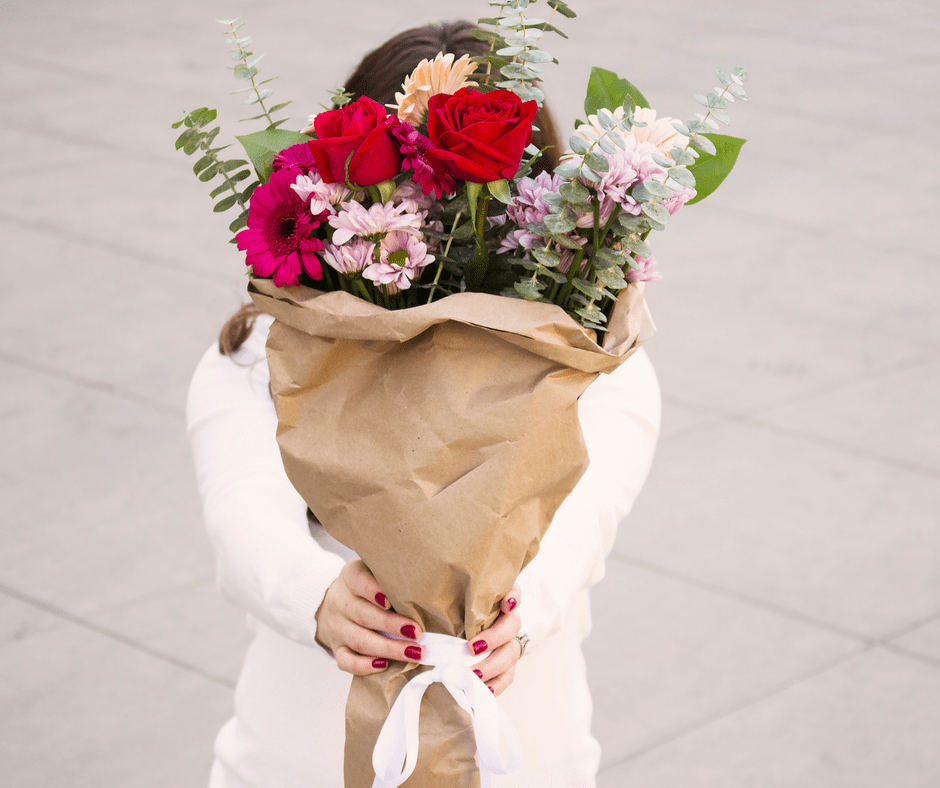 Woman holding out a bouquet of flowers