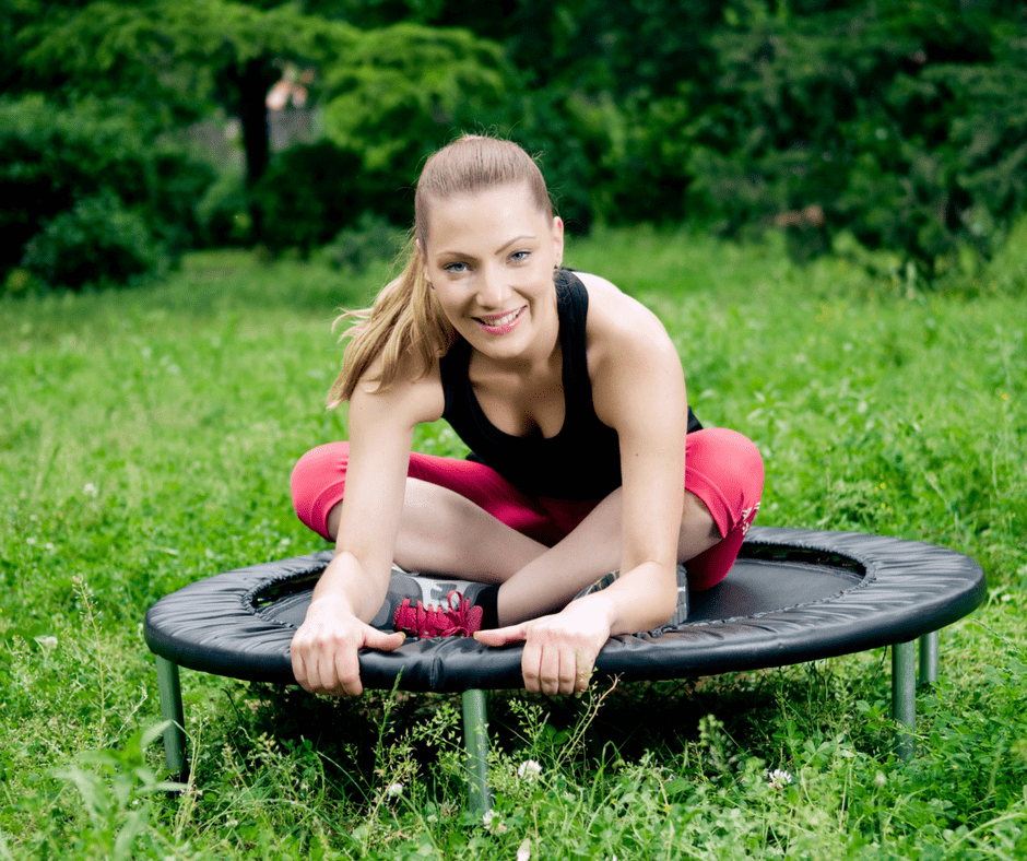 woman sitting on a rebounder outdoors