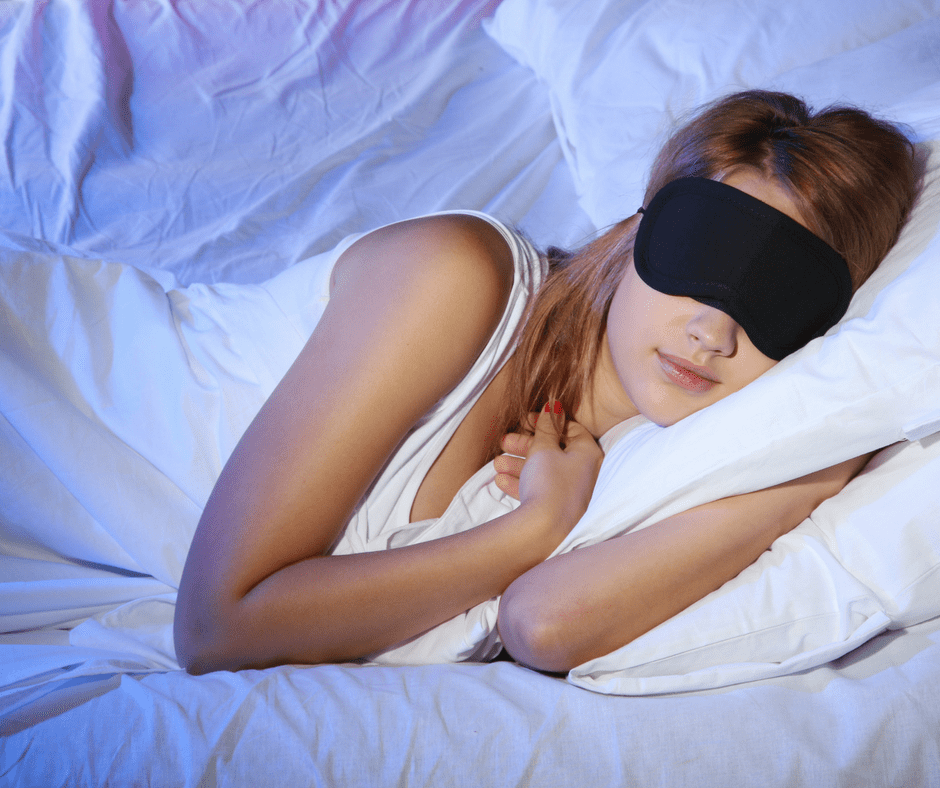 woman sleeping with a sleep mask