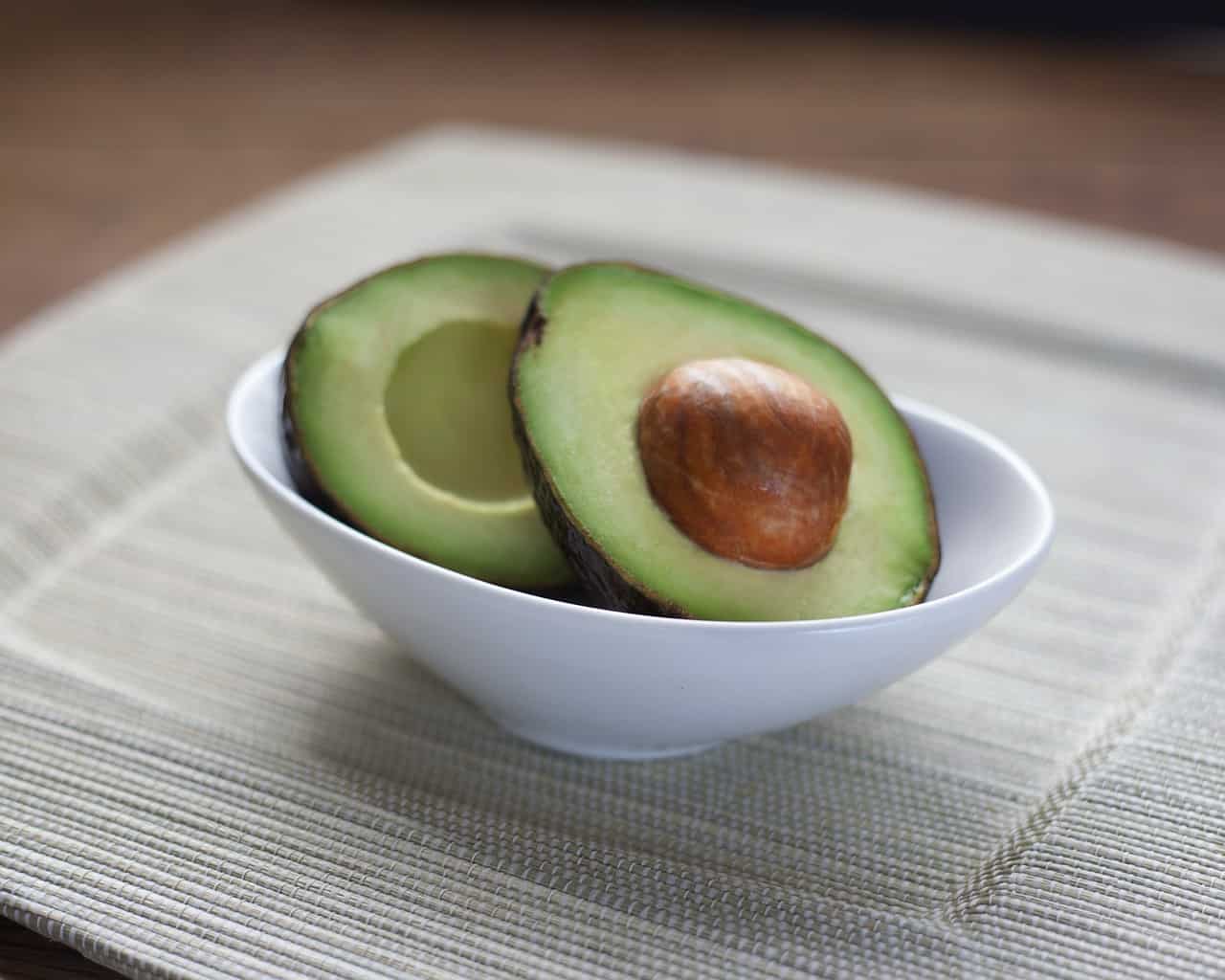 avocado cut in half in a bowl