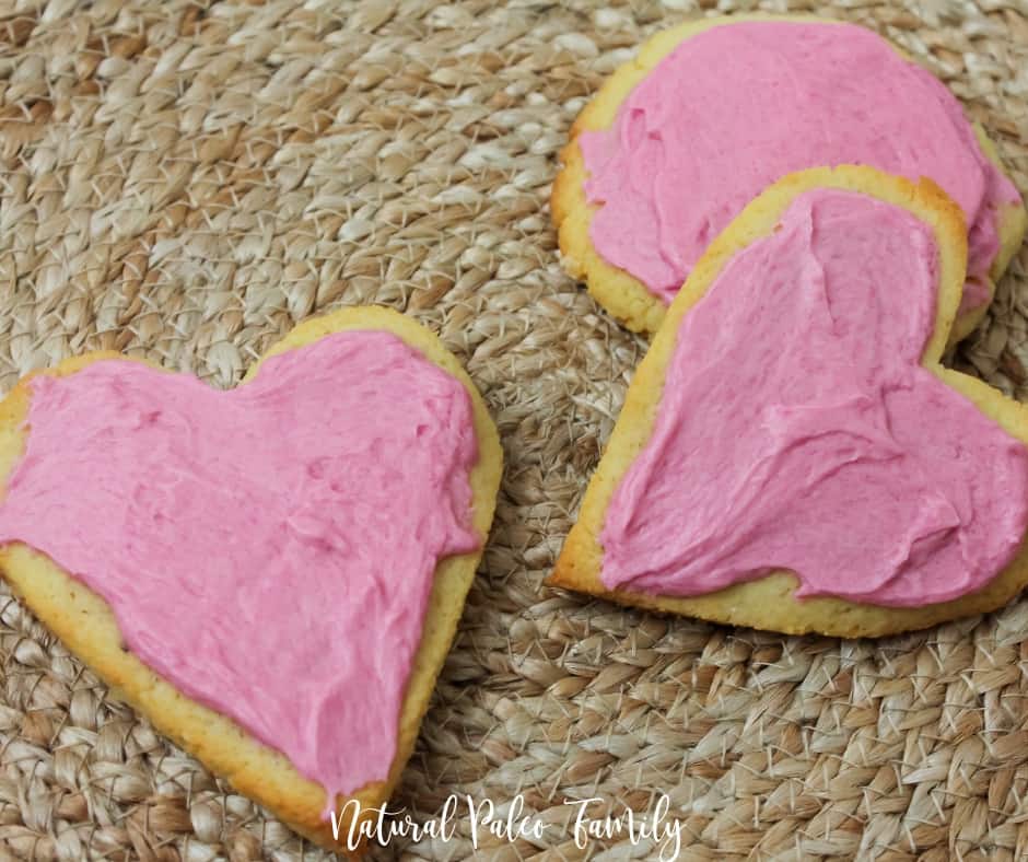three heart shaped paleo valentine's day cookies on a straw placemat