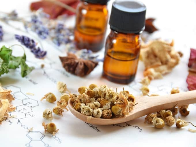 essential oil bottle and dried herbs